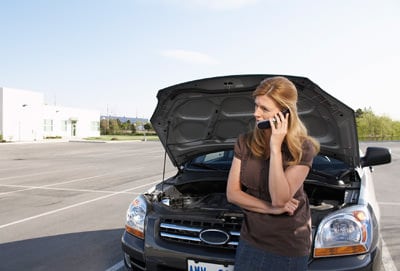Woman with a car with a battery problem