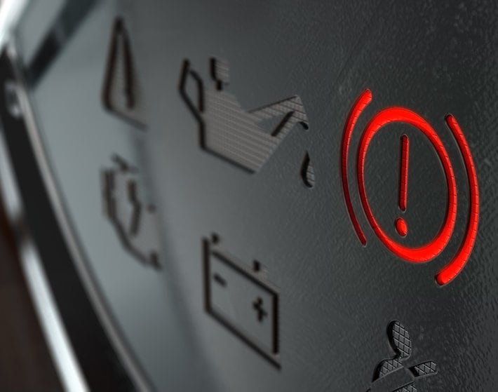 A 3D render of an extreme closeup of an illuminated brake dashboard light on an dashboard panel background