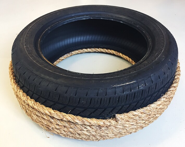 Wrapping rope around exterior of old tire