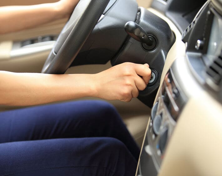 Woman turning the key in her ignition