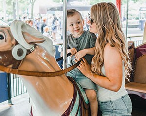 Mom and son on carousel