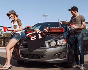 Couple tailgating next to car