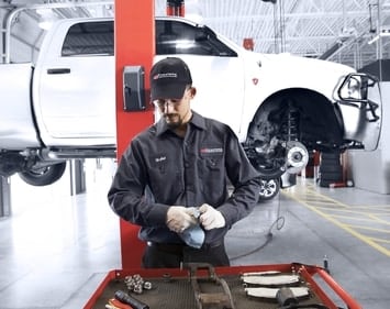 Skylar auto technician sets out brake components for car service