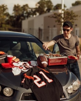 Tailgate supplies on hood of car