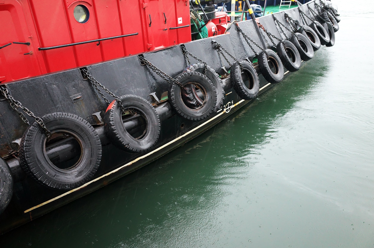 image of old car tires being reused as boat fenders